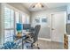 Functional home office with a large desk, comfortable chair, and natural light from window shutters at 103 Golf Club Dr, Longwood, FL 32779