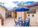 Cozy outdoor patio featuring brick accents, a table, chairs, and blue umbrella at 103 Golf Club Dr, Longwood, FL 32779