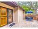 Cozy outdoor patio featuring brick accents, a table, chairs, and blue umbrella at 103 Golf Club Dr, Longwood, FL 32779