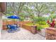 Outdoor patio area with brick accents featuring a table, chairs, and lush landscaping at 103 Golf Club Dr, Longwood, FL 32779