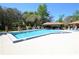 Bright community pool with lounge chairs and covered seating area at 103 Golf Club Dr, Longwood, FL 32779