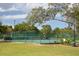 Outdoor tennis courts fenced with greenery providing recreation and a place to enjoy a match at 103 Golf Club Dr, Longwood, FL 32779