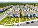 Aerial view of a well-manicured, blue, two-story townhome featuring a neat lawn and convenient street parking at 10915 Leafshore Loop, Orlando, FL 32829