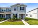 Charming two-story townhome with well-manicured lawn, featuring a welcoming front door at 10915 Leafshore Loop, Orlando, FL 32829