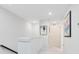 Upstairs hallway with neutral walls, carpet, and modern art at 10915 Leafshore Loop, Orlando, FL 32829