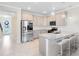 Modern kitchen features stainless steel appliances, granite countertops, and a cozy breakfast bar at 10915 Leafshore Loop, Orlando, FL 32829