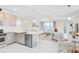 Bright, open-concept kitchen and living room with stainless steel appliances and modern lighting at 10915 Leafshore Loop, Orlando, FL 32829
