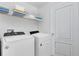 Laundry room featuring a Whirlpool washer and dryer set with a shelf at 10915 Leafshore Loop, Orlando, FL 32829