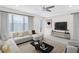Bright living room with modern decor, large windows, features comfortable sectional sofa at 10915 Leafshore Loop, Orlando, FL 32829