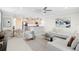 Modern open-concept living room with a well-lit kitchen and comfortable seating area at 10915 Leafshore Loop, Orlando, FL 32829