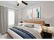 Stylishly furnished main bedroom featuring a leather headboard, two side tables, and modern art at 10915 Leafshore Loop, Orlando, FL 32829