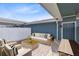 Cozy outdoor patio with a stylish sofa, coffee table, and chairs at 10915 Leafshore Loop, Orlando, FL 32829