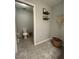 Half bath featuring floating shelves and neutral decor at 11 Pecan Run Ct, Ocala, FL 34472