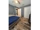 Bedroom featuring wood-look floors, closet, ceiling fan and natural light at 11 Pecan Run Ct, Ocala, FL 34472