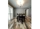 Dining room features a modern chandelier, lots of light, and unique floor tiles at 11 Pecan Run Ct, Ocala, FL 34472