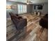 Relaxing living room with stylish floors, comfortable seating, ceiling fan and large windows for natural light at 11 Pecan Run Ct, Ocala, FL 34472