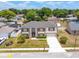 An aerial view showcasing a beautifully landscaped home with a spacious driveway, set in a serene residential neighborhood at 114 Shaddock Dr, Auburndale, FL 33823