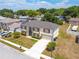 A bird's-eye view of a charming home with a well-kept lawn, highlighting its prime location within a friendly community at 114 Shaddock Dr, Auburndale, FL 33823