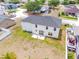 The home features an open backyard and a clean exterior, situated in a peaceful neighborhood with lush green surroundings at 114 Shaddock Dr, Auburndale, FL 33823