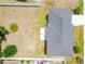 Aerial shot of the roof and backyard, which shows a yard with a palm tree and potential for landscaping at 114 Shaddock Dr, Auburndale, FL 33823