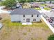 An aerial view showing a well-maintained backyard and the home's exterior, within a tranquil and established neighborhood at 114 Shaddock Dr, Auburndale, FL 33823