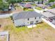 The house boasts a spacious backyard and well-kept exterior, found in a quiet neighborhood with mature trees and tidy lawns at 114 Shaddock Dr, Auburndale, FL 33823