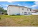 Backyard with a large home featuring a lawn at 114 Shaddock Dr, Auburndale, FL 33823