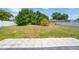 Fenced backyard with a palm tree, grass and tiled patio at 114 Shaddock Dr, Auburndale, FL 33823