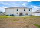 Backyard with a large home featuring a lawn at 114 Shaddock Dr, Auburndale, FL 33823