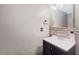 Bathroom featuring a wooden cabinet sink with a neutral wall and a decorative backsplash at 114 Shaddock Dr, Auburndale, FL 33823