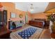 Well-lit bedroom featuring wood-look flooring, a wooden bed frame, and a large area rug at 114 Shaddock Dr, Auburndale, FL 33823