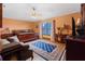 Bright bedroom with a large window, ceiling fan, and a wooden bed frame at 114 Shaddock Dr, Auburndale, FL 33823