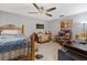 Bedroom with a ceiling fan, artwork on the walls, and tiled floors at 114 Shaddock Dr, Auburndale, FL 33823