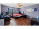 Bedroom with a bed, desk, and hardwood floors, offering a versatile space at 114 Shaddock Dr, Auburndale, FL 33823