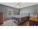 Bedroom with a ceiling fan, window and an area rug on wood floor at 114 Shaddock Dr, Auburndale, FL 33823