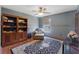 Bedroom featuring a fan, a built-in bookcase, a lounger and an area rug at 114 Shaddock Dr, Auburndale, FL 33823