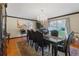 Formal dining room featuring a large window, chandelier, and seating for six at 114 Shaddock Dr, Auburndale, FL 33823