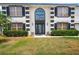 Close up of a home's front entrance with a decorated glass door, and elegant landscaping at 114 Shaddock Dr, Auburndale, FL 33823