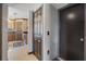 Hallway view with tile flooring leading to a kitchen with wood cabinets and stainless steel appliances at 114 Shaddock Dr, Auburndale, FL 33823
