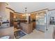 Well-equipped kitchen featuring a center island, stainless steel appliances, and warm wood cabinetry at 114 Shaddock Dr, Auburndale, FL 33823