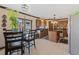 Open kitchen with stainless steel appliances, wooden cabinets, and a dining table near the window at 114 Shaddock Dr, Auburndale, FL 33823