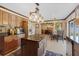Open kitchen with stainless steel refrigerator, dark countertop island, and view to the dining room at 114 Shaddock Dr, Auburndale, FL 33823