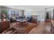 Comfortable living room with hardwood floors, leather sofa, large rug, and staircase at 114 Shaddock Dr, Auburndale, FL 33823