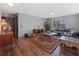 Spacious living room with hardwood floors, a leather sofa, and a large area rug at 114 Shaddock Dr, Auburndale, FL 33823