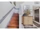 Wooden staircase with decorative wainscoting and an ornamental table at 114 Shaddock Dr, Auburndale, FL 33823