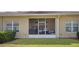 Home's exterior features a screened lanai, manicured lawn and tidy landscaping at 1161 Trappers Trail Loop, Davenport, FL 33896