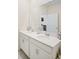 Bright bathroom with double sink vanity, white cabinets and a large mirror at 1161 Trappers Trail Loop, Davenport, FL 33896