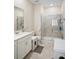 Bright bathroom featuring white cabinetry, and shower with sliding glass door at 1161 Trappers Trail Loop, Davenport, FL 33896
