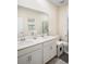 Bright bathroom features a double sink vanity with white cabinets and a glass enclosed shower at 1161 Trappers Trail Loop, Davenport, FL 33896