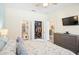 Bright bedroom featuring mounted TV and a doorway to the en suite at 1161 Trappers Trail Loop, Davenport, FL 33896